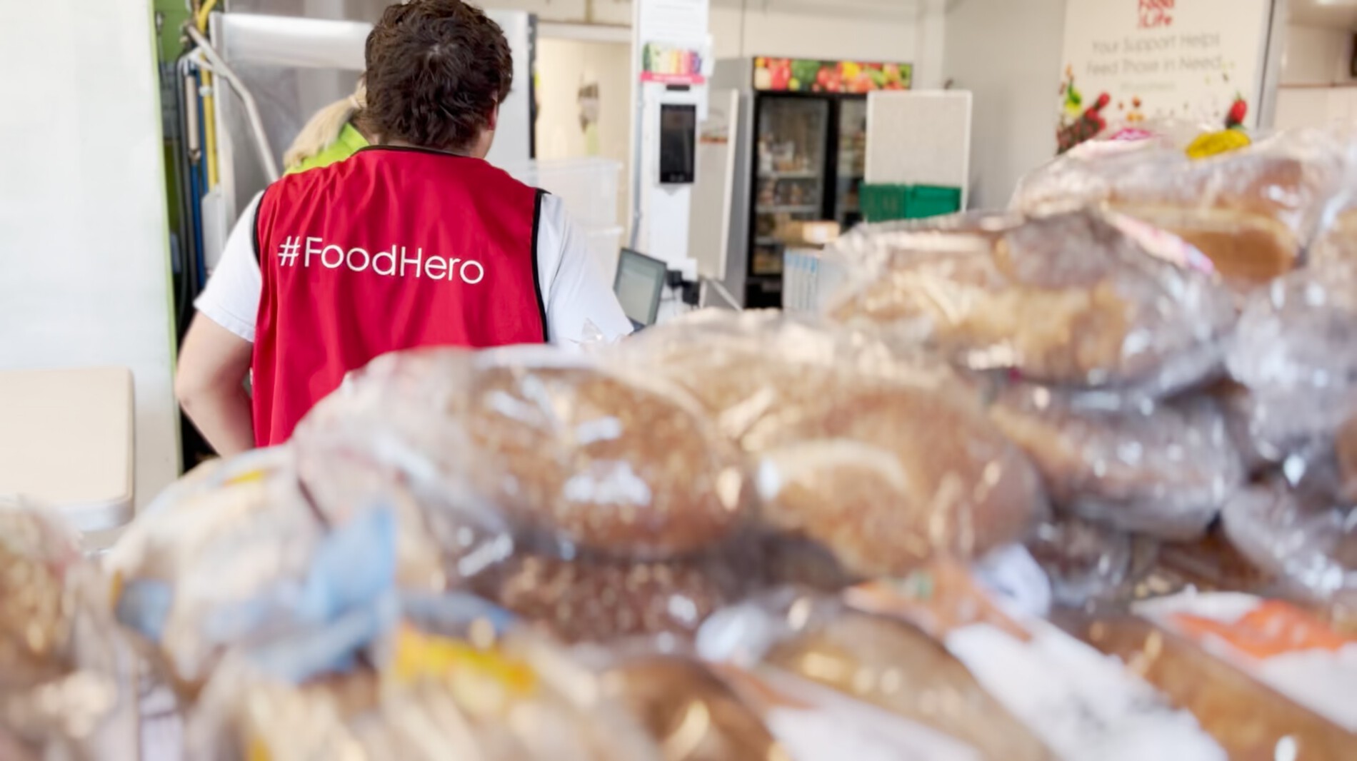 A volunteer packing food.